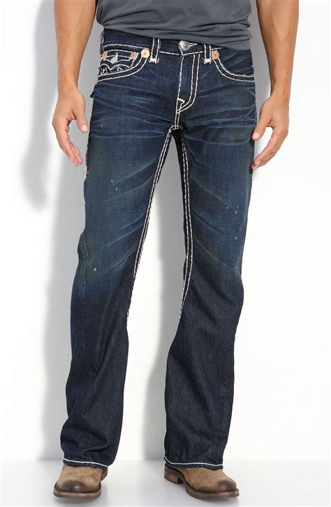 This classic five pocket design features traditional details like branded hardware, orange bar tack seams, and a hay-colored topstitch with a handcrafted wash to complement the features. . True religion mens bootcut jeans